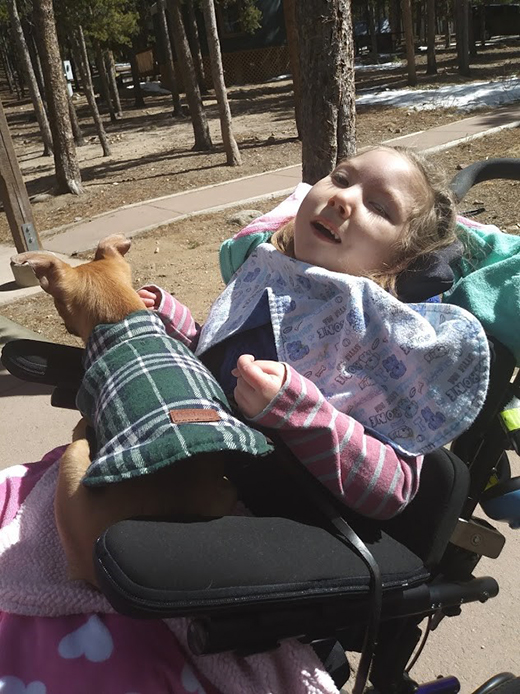 Child using a wheelchair on a trail