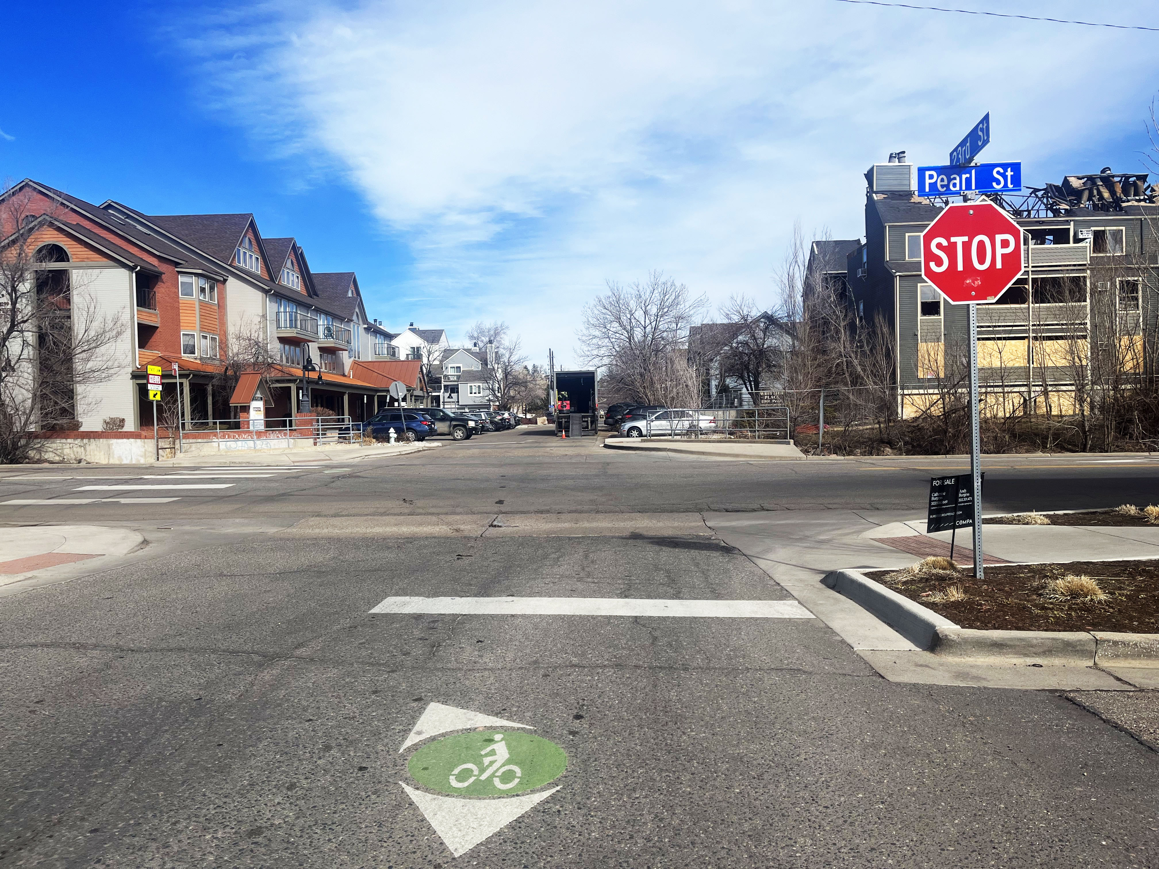 a wayfinding symbol on the road near a stop sign