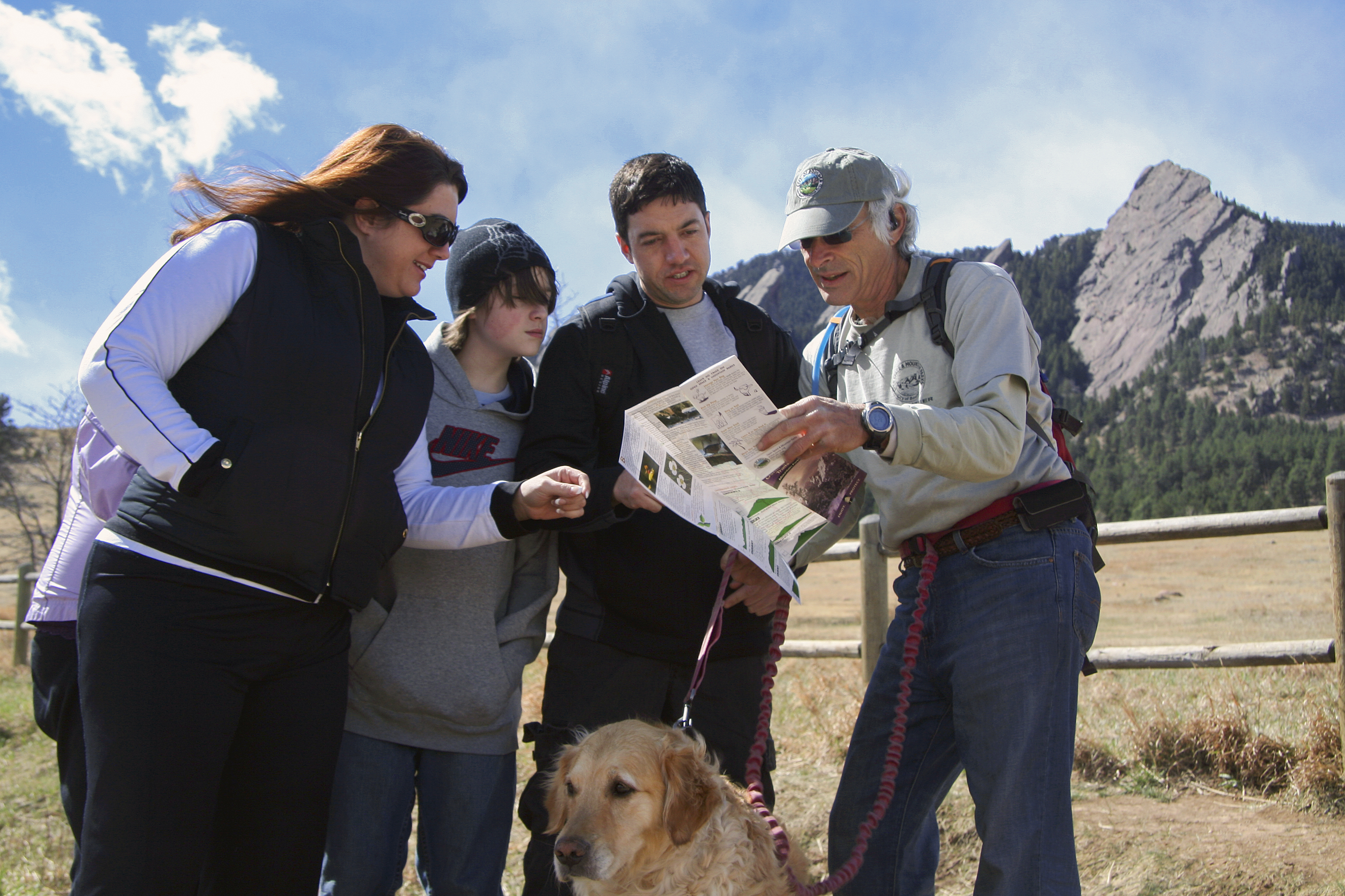 Volunteer Trail Guide, Rich Wolf, showing visitors a map