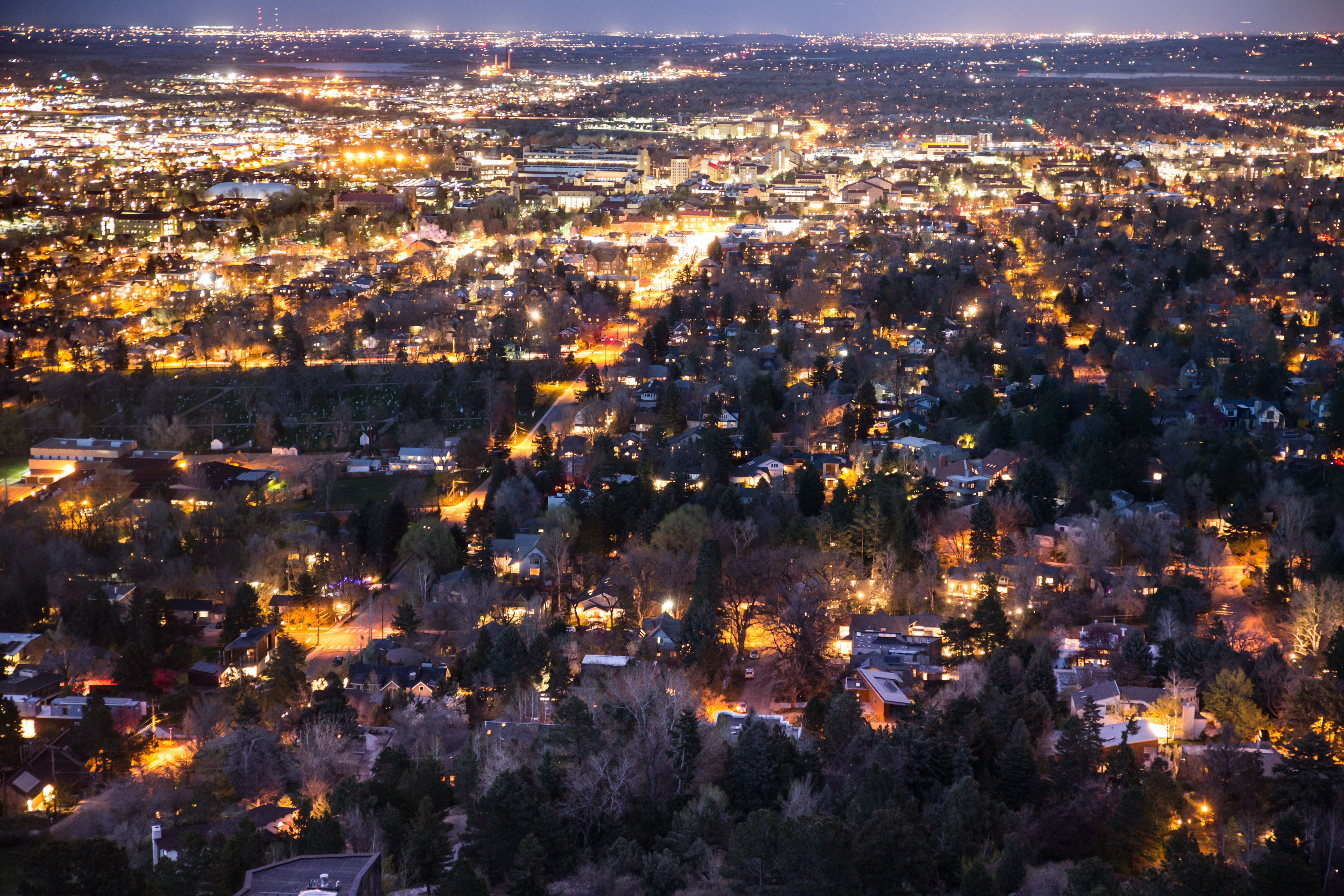 an aerial view of warm lights in Boulder at night