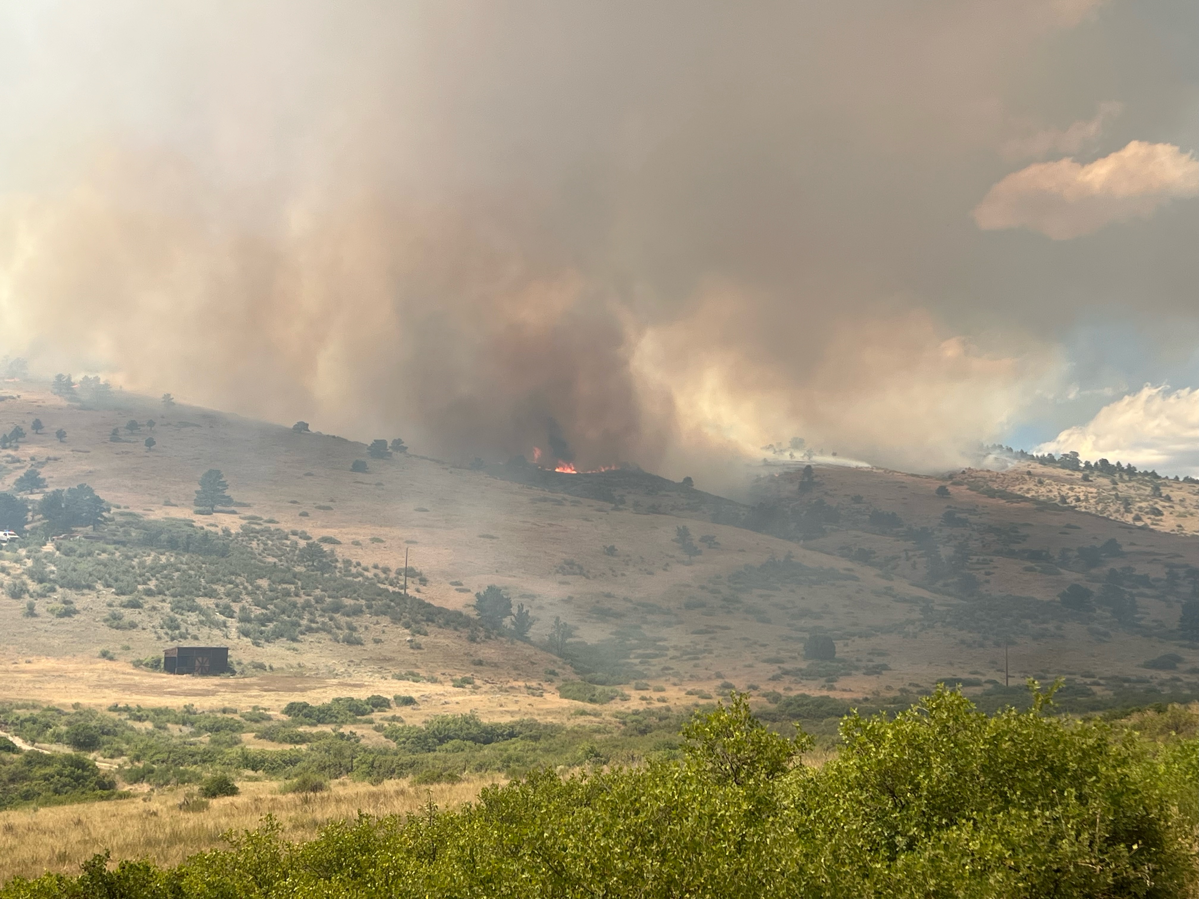 wildfire burns on a hill