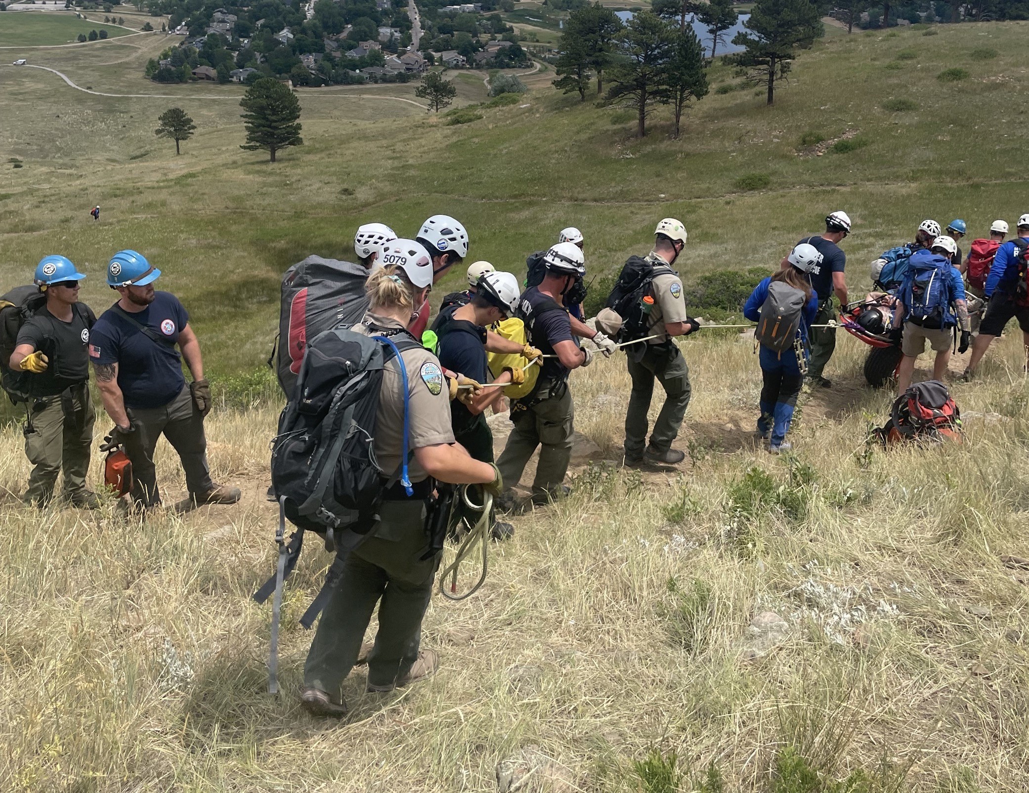 First responders evacuating patient after rescue using walking belay