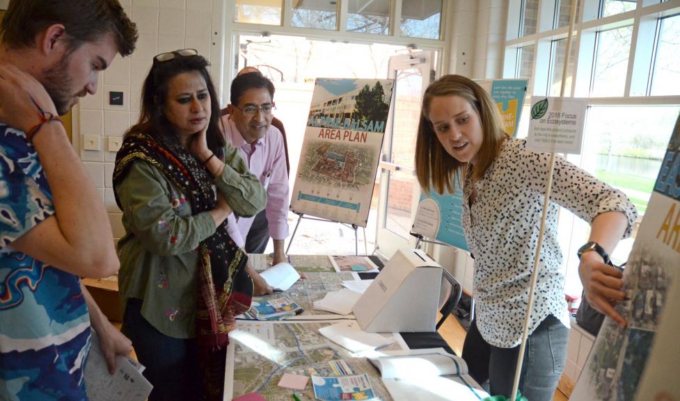 Community members interact with city staff at a public event