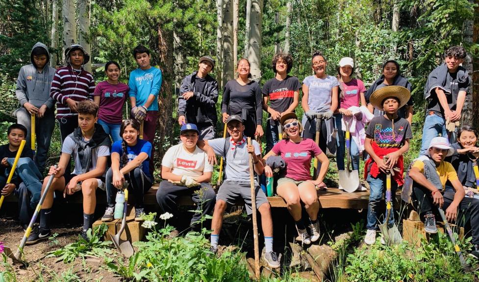 Picture of teenagers in a forest with trail maintenance tools