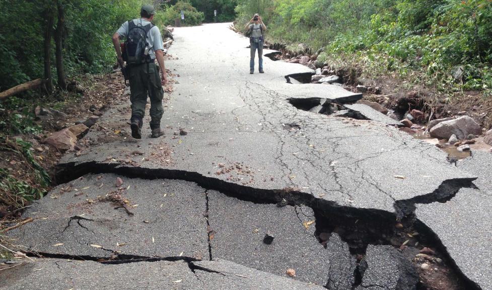 OSMP staff survey flood damage along Gregory Canyon Drive