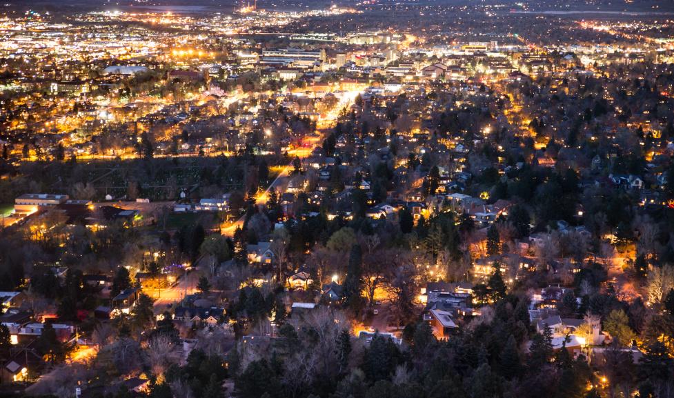 an aerial view of warm lights in Boulder at night