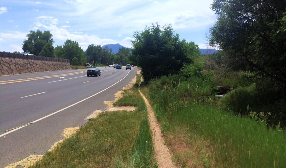 Skinny dirt path for people walking next to Valmont Road