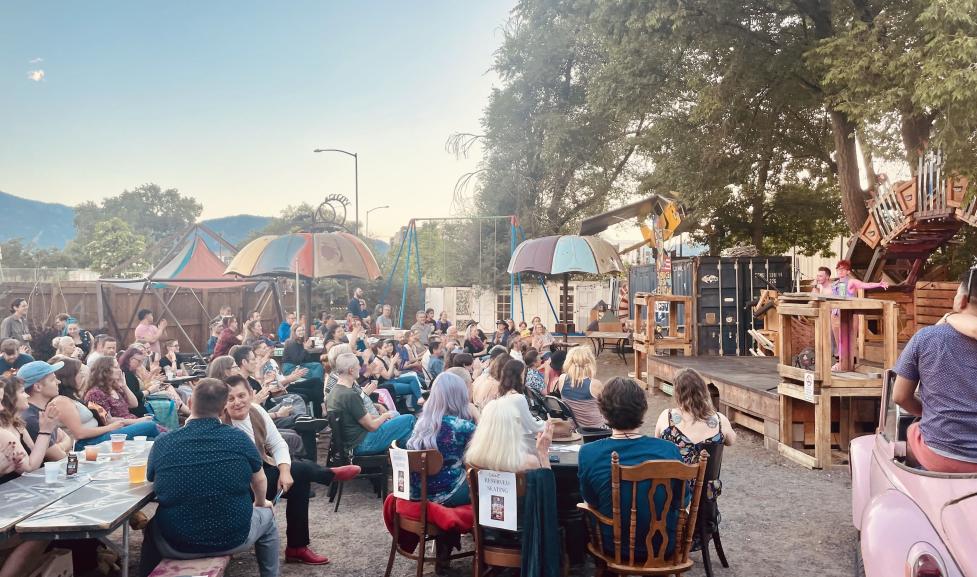 Audience listening to artists outside at Junkyard Social Club