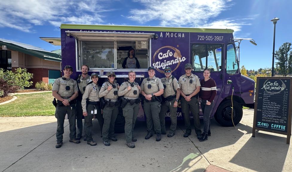 9 Rangers standing in front of a purple coffee truck on a sunny day