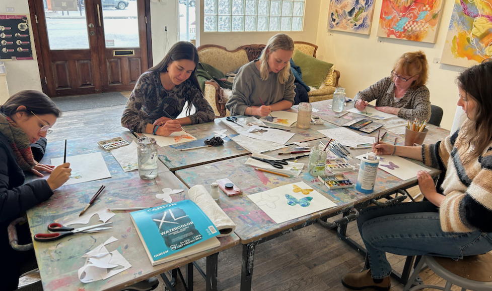 Women working on art together at The New Local