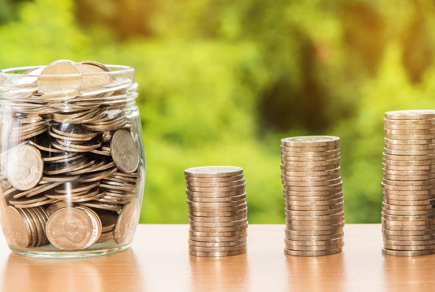 Coins stacked and in a jar