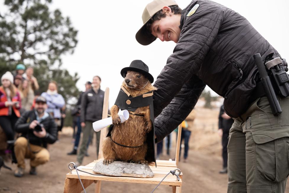 OSMP Ranger helps Flatiron Freddy get off a dog sled