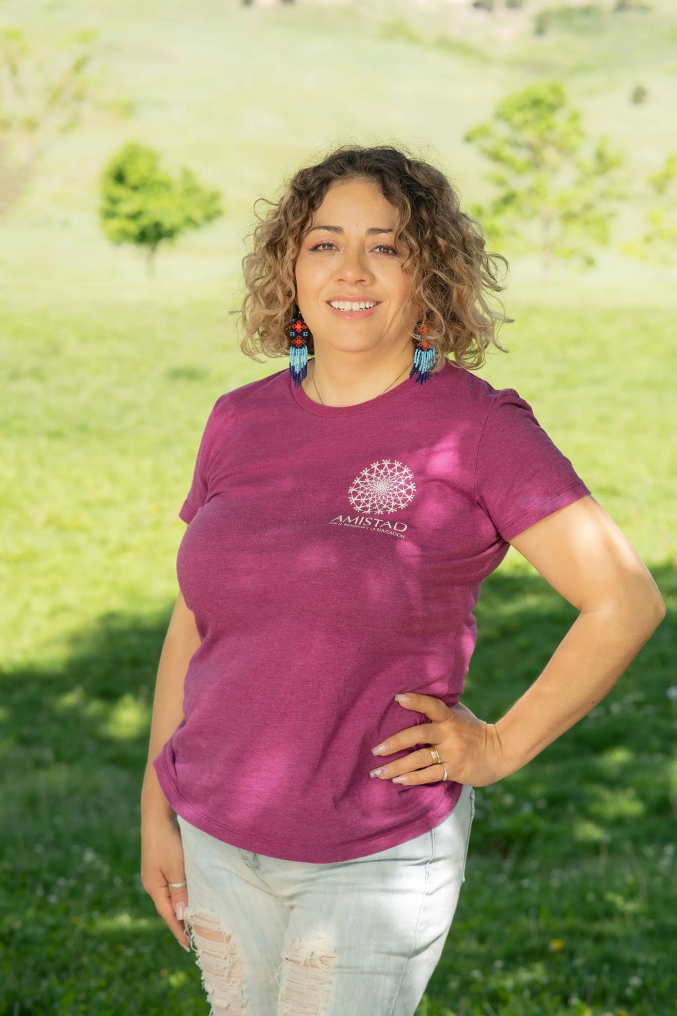 Guadalupe Jaime posing for the camera in a burgundy shirt.