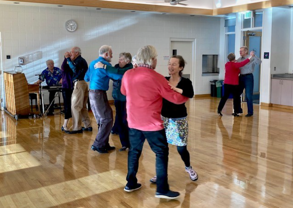 Older adults dance to live music in the East Age Well Center ballroom