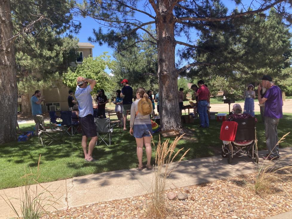 People standing outside for a neighborhood picnic