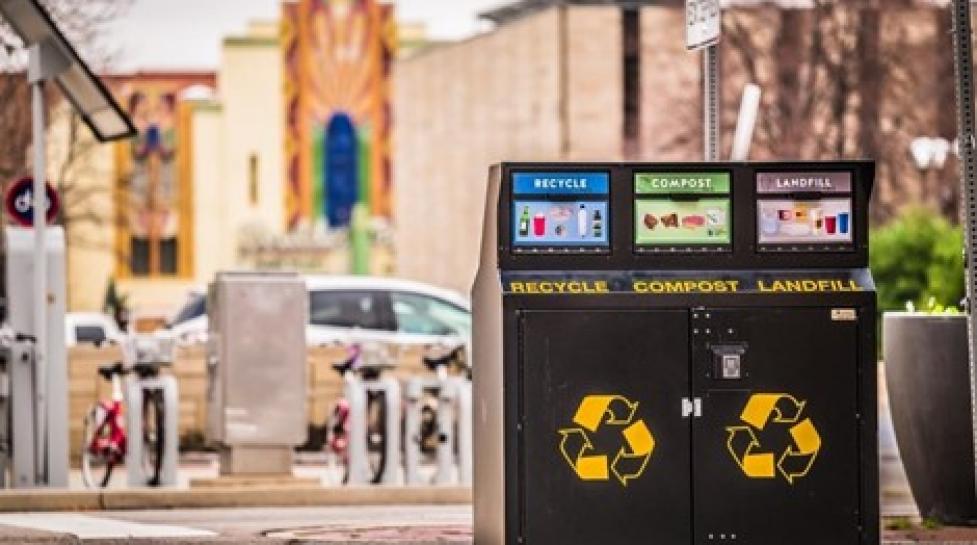 Photo of a trash, compost, recycle bin, Boulder Theater in the background.