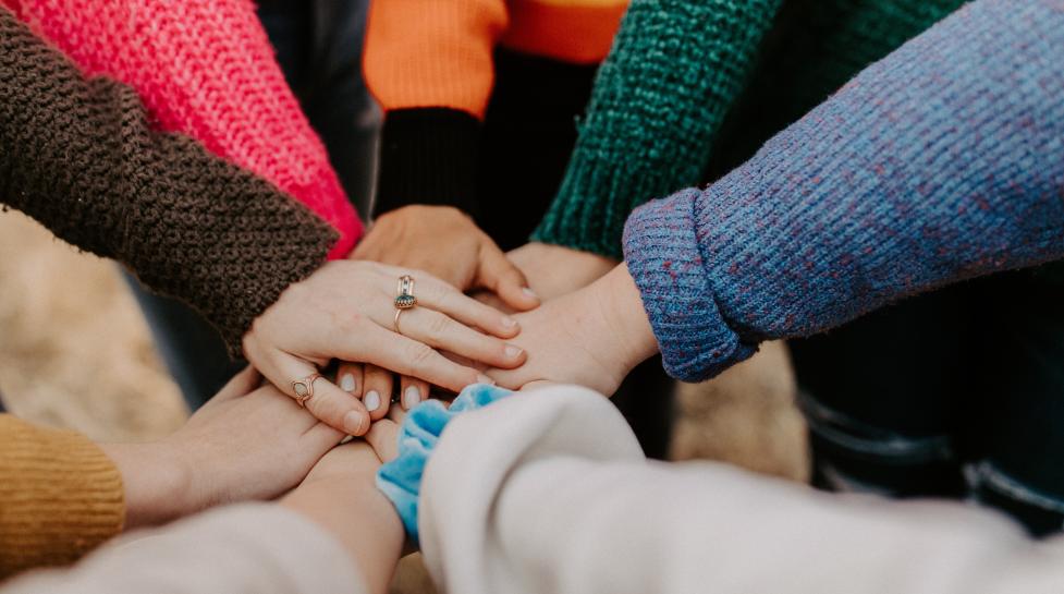 Eight hands together from people in a circle