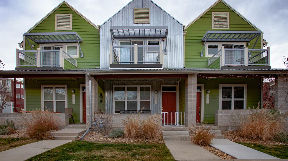 View of three attached townhomes from sidewalk