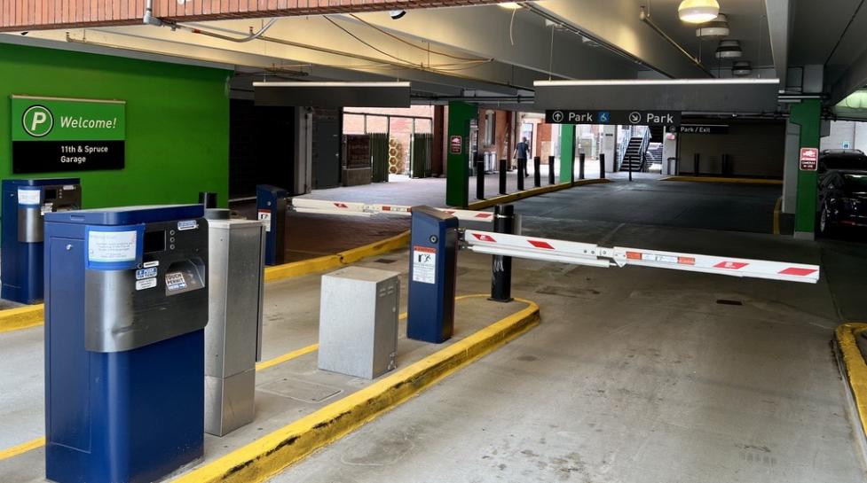 Photo of the entrance to the BoulderPark Garage at 11th and Spruce streets, showing the gates and ticket payment kiosk