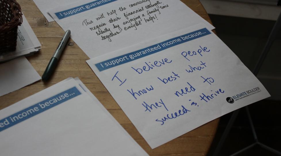 Paper with the prompt 'I support guaranteed income because...' that reads 'I believe people know best what they need to succeed & thrive'