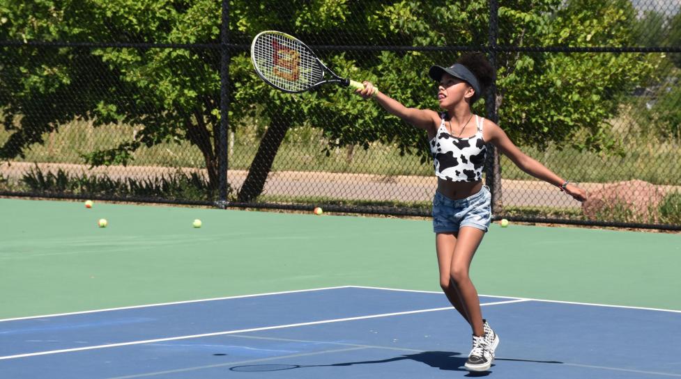 Girl playing tennis at East Boulder Community Center