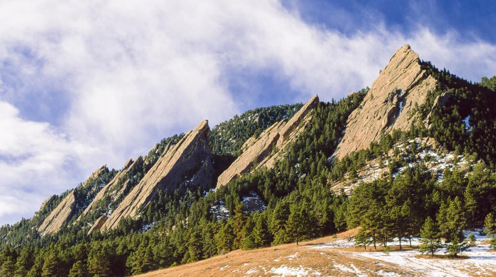 Clouds pass over the Boulder Flatirons