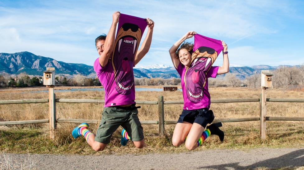 Jeff and Paige jump into the air at the Cherryvale Trailhead in east Boulder.