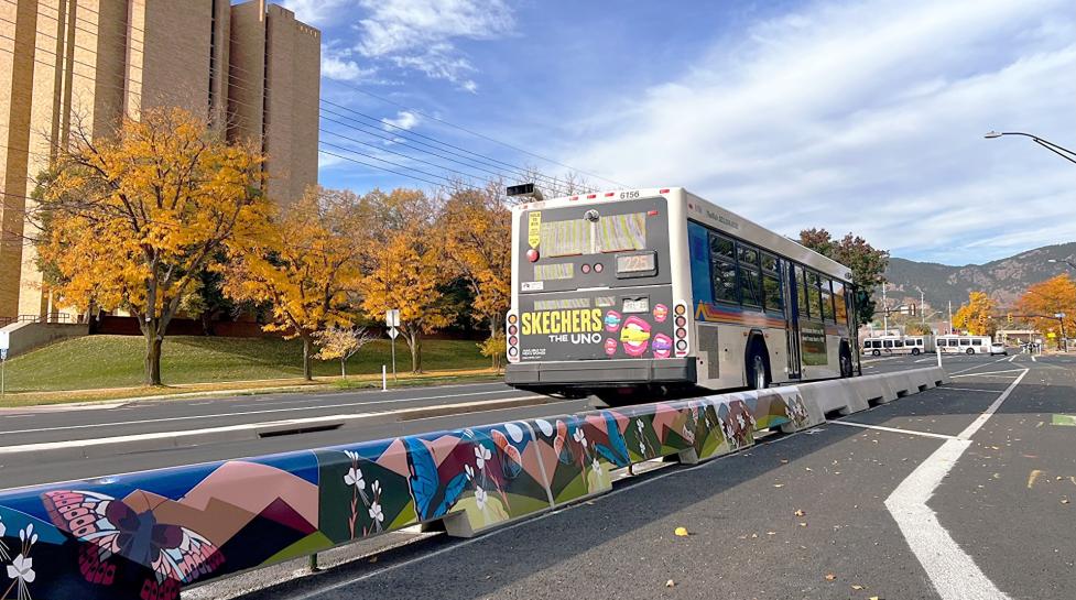 Bus along Baseline Road in the fall next to a concrete-tall-curb protected bike lane