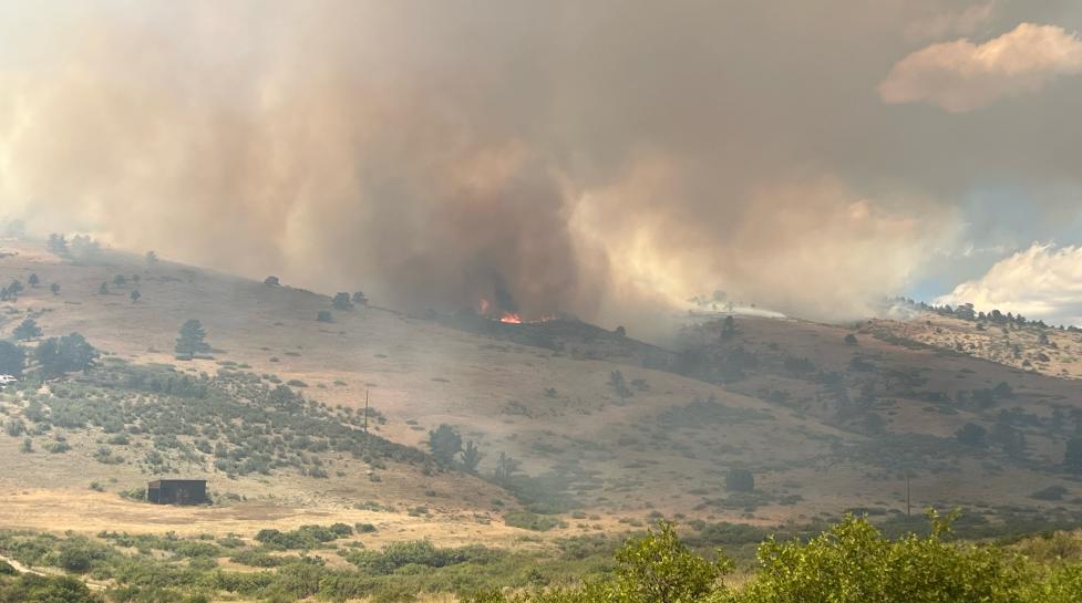 wildfire smoke comes up and over the hill in Boulder County Colorado