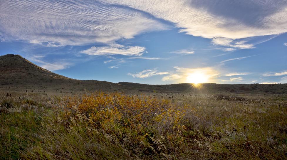 Sun sets over western Boulder Valley Ranch north of Boulder