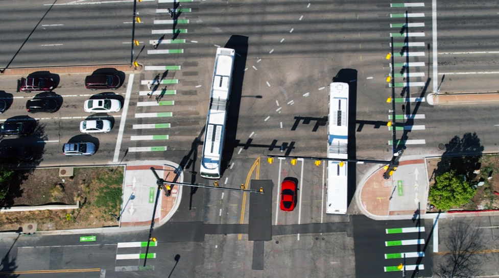 28th and Colorado intersection from above. Buses, cars, bikes and people walking travel. 