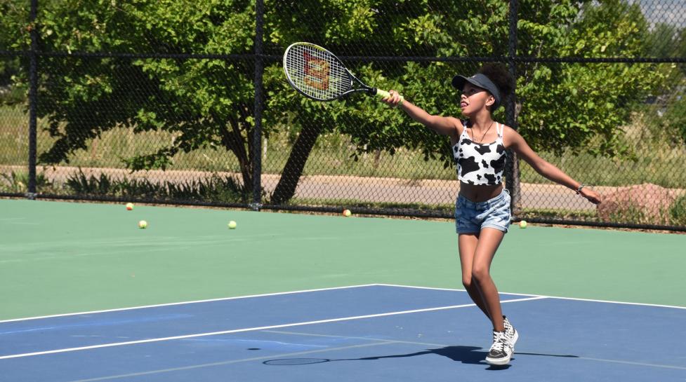 Kid playing tennis at the East Boulder Community Park tennis courts