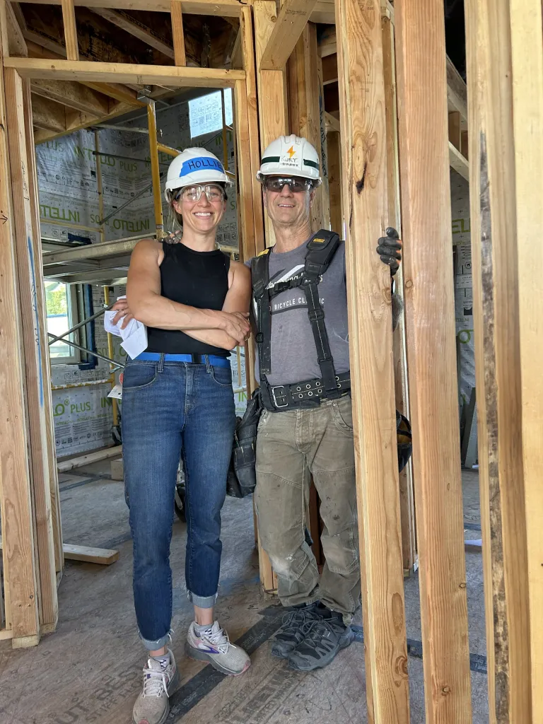 Hollie and Kurt in a mid-construction Habitat for Humanity home.