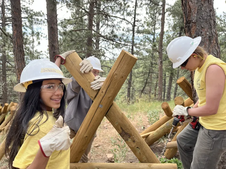 Junior Rangers work together to build a fence