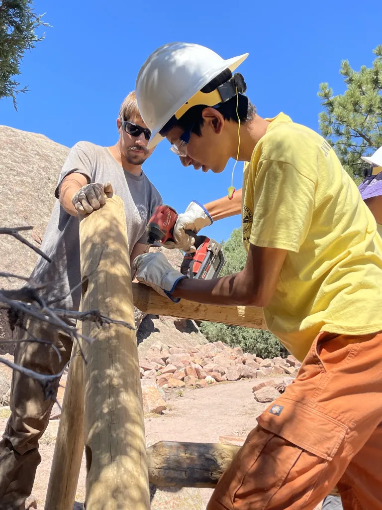 A junior ranger builds a fence