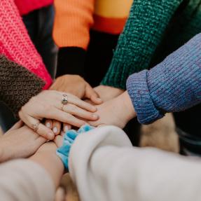 Eight hands together from people in a circle