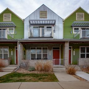 View of three attached townhomes from sidewalk