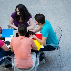 Group of five individuals collaborating around a table