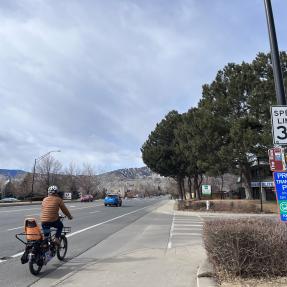 A person biking down Iris Avenue