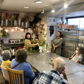 Seniors learning how to create a flower arrangement