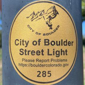 City of Boulder streetlight sticker, gold with black letters