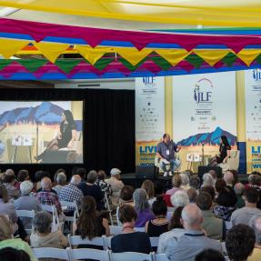 Speakers listening to presenters at JLF Colorado.