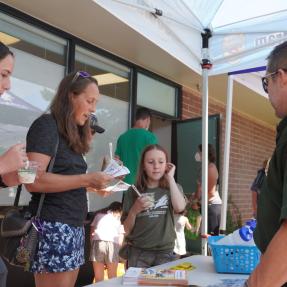 Transportation staff talking to family and kid eating ice cream