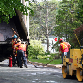 construction workers repair pothole