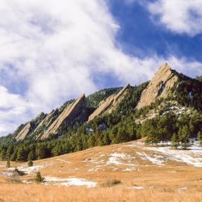 Clouds pass over the Boulder Flatirons