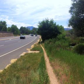 Skinny dirt path for people walking next to Valmont Road