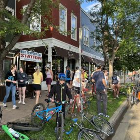 People and bikes gathered outside a breakfast station on Bike to Work Day