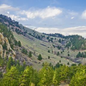 Clouds pass over Mount Sanitas and the Sanitas Valley Trail