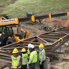 Pieces of the South Bridge and construction equipment sit on the North Sky Trail