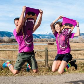 Jeff and Paige jump into the air at the Cherryvale Trailhead in east Boulder.